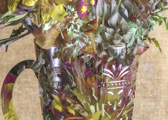 Floral bouquet with vintage glass vase.