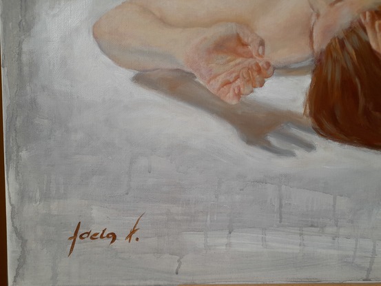 Foreshortened lying female nude on a hard floor.