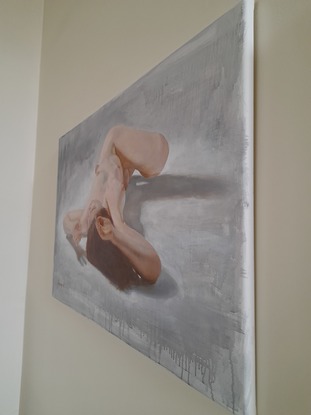 Foreshortened lying female nude on a hard floor.