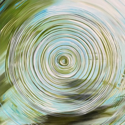 Raindrop on water with leafy green reflections