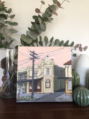 This is a painting of an old building on Darling Street In  East Balmain. While it is basically realistic it is not phot realism but more an expressionist style. The sky is pink as it is early evening and the building has a yellow glow.