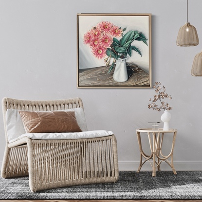 Flowering gum in milk jug on rustic timber table