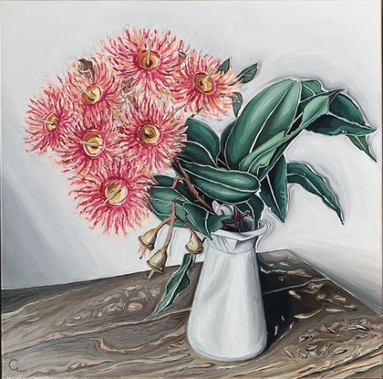 Flowering gum in milk jug on rustic timber table