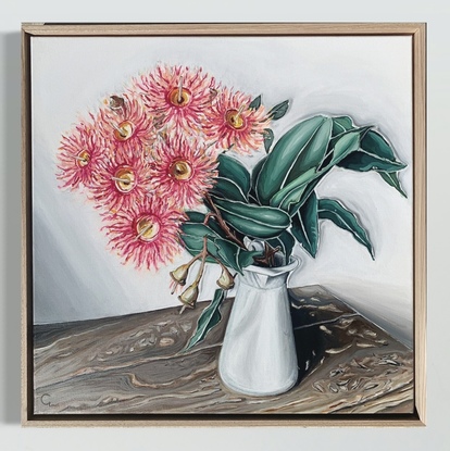 Flowering gum in milk jug on rustic timber table