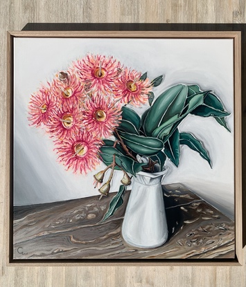 Flowering gum in milk jug on rustic timber table