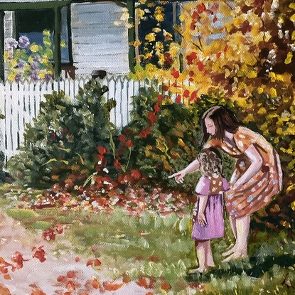 Woman and child looking at autumn leaves in front of a cottage