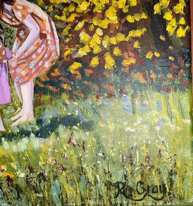 Woman and child looking at autumn leaves in front of a cottage