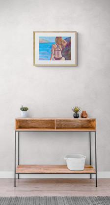 Woman sitting amongst the rocks by the ocean