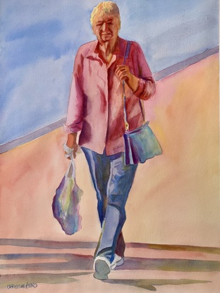 Woman carries shopping as she makes her way home.