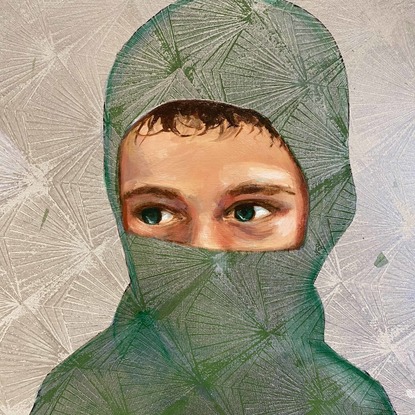 A portrait of a boy wearing a mask that reveals his green eyes.