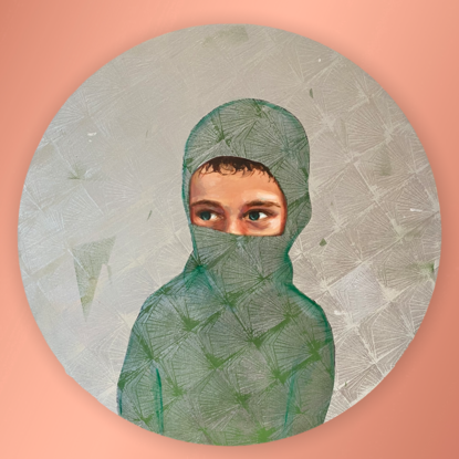 A portrait of a boy wearing a mask that reveals his green eyes.