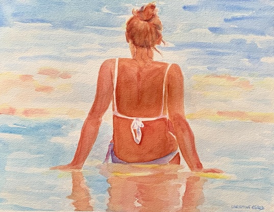 Woman relaxes in the sea in the sunshine.