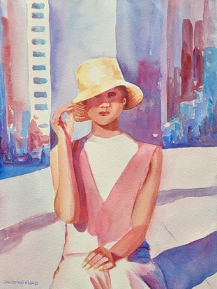 Woman sitting wearing a sun hat in the sunshine.