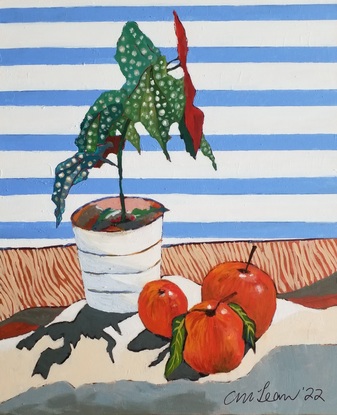 A vibrant green leaf with white spots and a deep maroon underleaf, in a white vase with 3 large red apples against white shutters and a clear blue sky.