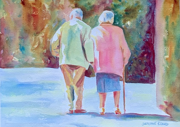 Elderly couple walk in the sunshine.