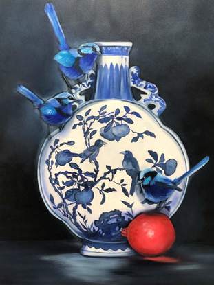 Three blue fairy wrens on a blue and white vase, with a pomegranate. 