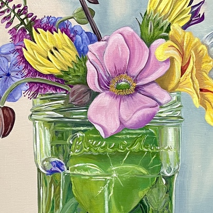 Garden flowers arranged in a glass jar.