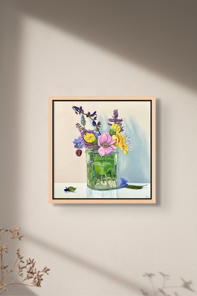 Garden flowers arranged in a glass jar.