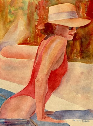 Woman at the edge of the pool wearing sunglasses in the sunshine.