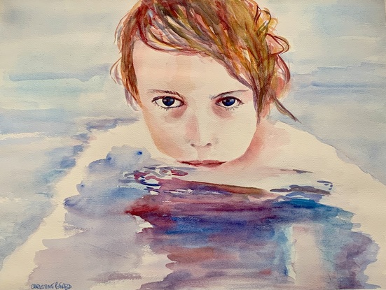 A young boy swims in a pool.