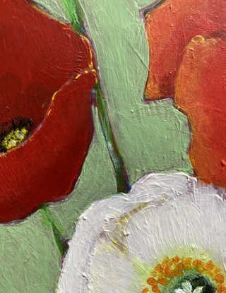 Still life of colourful poppies in glass vase