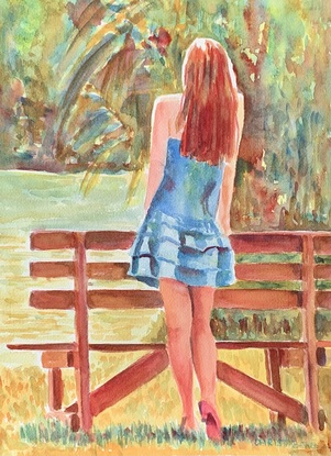 Woman standing leaning on a bench in the sunshine.