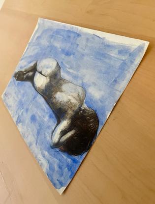 A woman lying down in a blue background