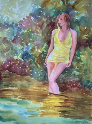 Woman stands in shady pond.