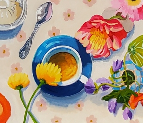 An aerial view of a table set for afternoon tea with cream floral tablecloth blue cups and saucers and a blue and green teapot.  A glass sugarbowl and variety of flowers in vases.