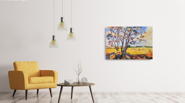 a field of gold under a blue and cream sky with distant blue ranges and a farm with a herd of cows grazing and a couple of gum trees with quirky foreground colours