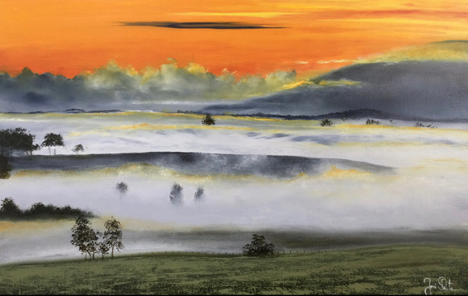 Foggy countryside with mountains and  Orange sky