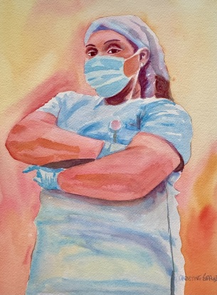 Woman wearing a face mask and scrubs.
