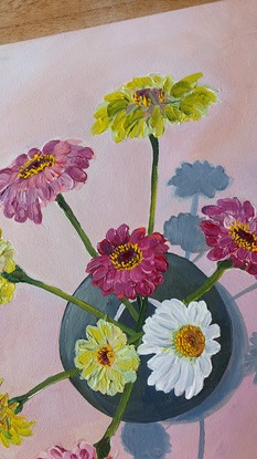 A birds-eye view of some Scenic Rim flowers in a round vase beside an antique blue plate and silver vintage sugar spoon.