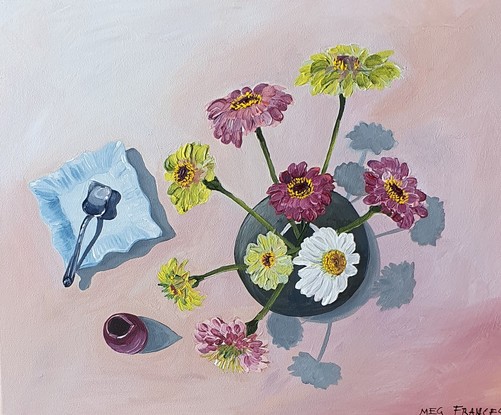 A birds-eye view of some Scenic Rim flowers in a round vase beside an antique blue plate and silver vintage sugar spoon.