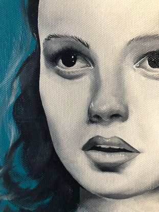 Black and white portrait of actress Judy Garland. Turquoise background with expressive brushstrokes around the figure. 