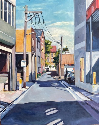 an urban back lane showing the buildings and their shadows on either side, with a public school in the distance. Framed in oak