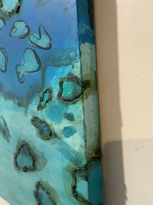 The work is an aerial view of the reef incorporating raised element to bring the painting to life.  It's as though you can reach out and touch the reef.