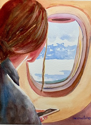 Woman looks out of an airplane window.