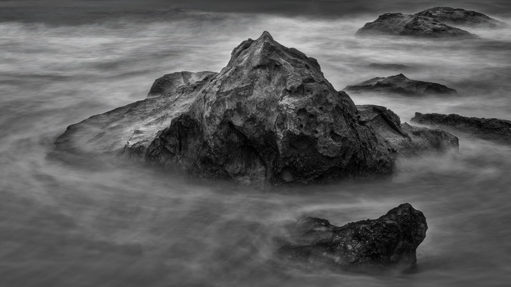 A long exposure photograph of the rock and water