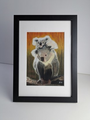 A mother Koala with her Joey clinging to her back fleeing the raging Bushfire in the background.