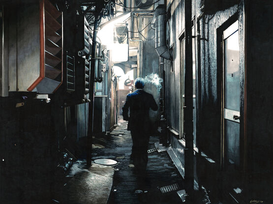 Dark alley in Tokyo with a man smoking