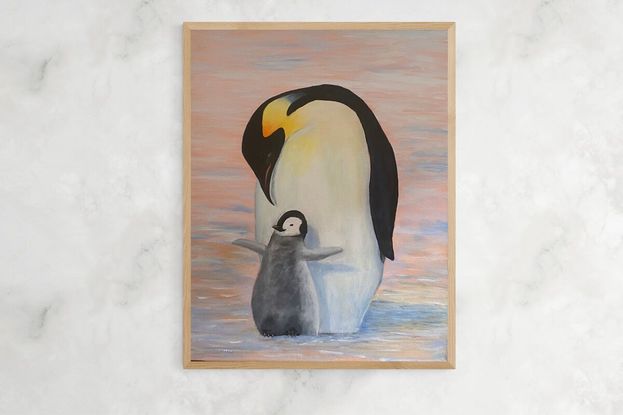 An elegant Mother Emperor penguin and her adorable baby curling up together on the ice, staying warm, and watching for predators.