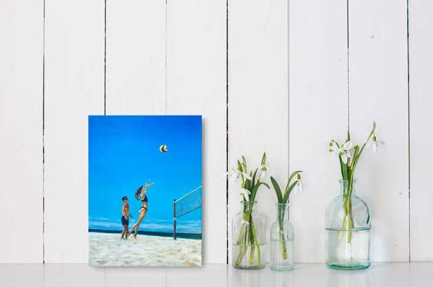 A couple of friends playing beach volleyball on the surfers paradise broad beach Gold Coast.