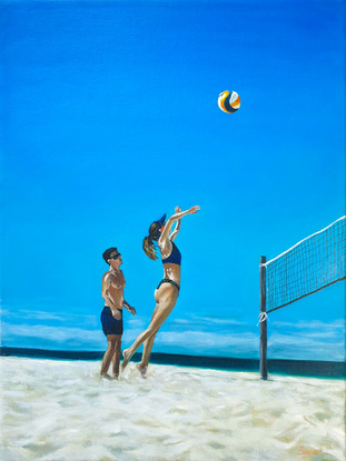 A couple of friends playing beach volleyball on the surfers paradise broad beach Gold Coast.