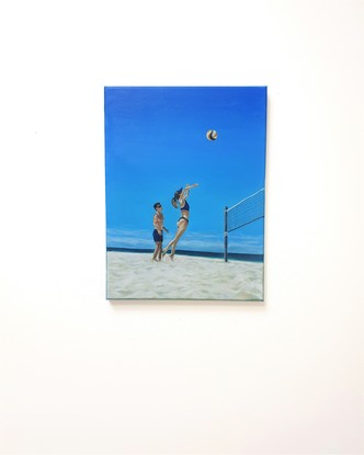 A couple of friends playing beach volleyball on the surfers paradise broad beach Gold Coast.