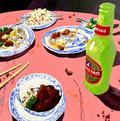 Still life of food and drink at a Chinese restaurant with pink tablecloth and bright green beer bottle