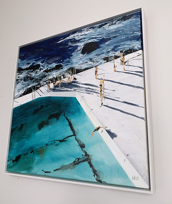 People standing between ocean and pool