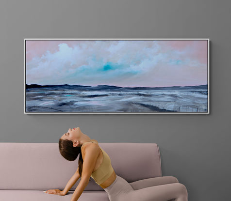 Colourful and fresh abstract seascape in teal and pink tones with mountain range in the horizon under cloudy sky.