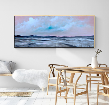 Colourful and fresh abstract seascape in teal and pink tones with mountain range in the horizon under cloudy sky.