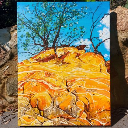 A bright blue sky with some whit fluffy clouds is the backdrop for this painting. This is fronted by a view looking up the cliffs of dripstone geology formed of orange and yellow colours banded and marbled. At the top of the cliff are two twisty trees with green leaves.